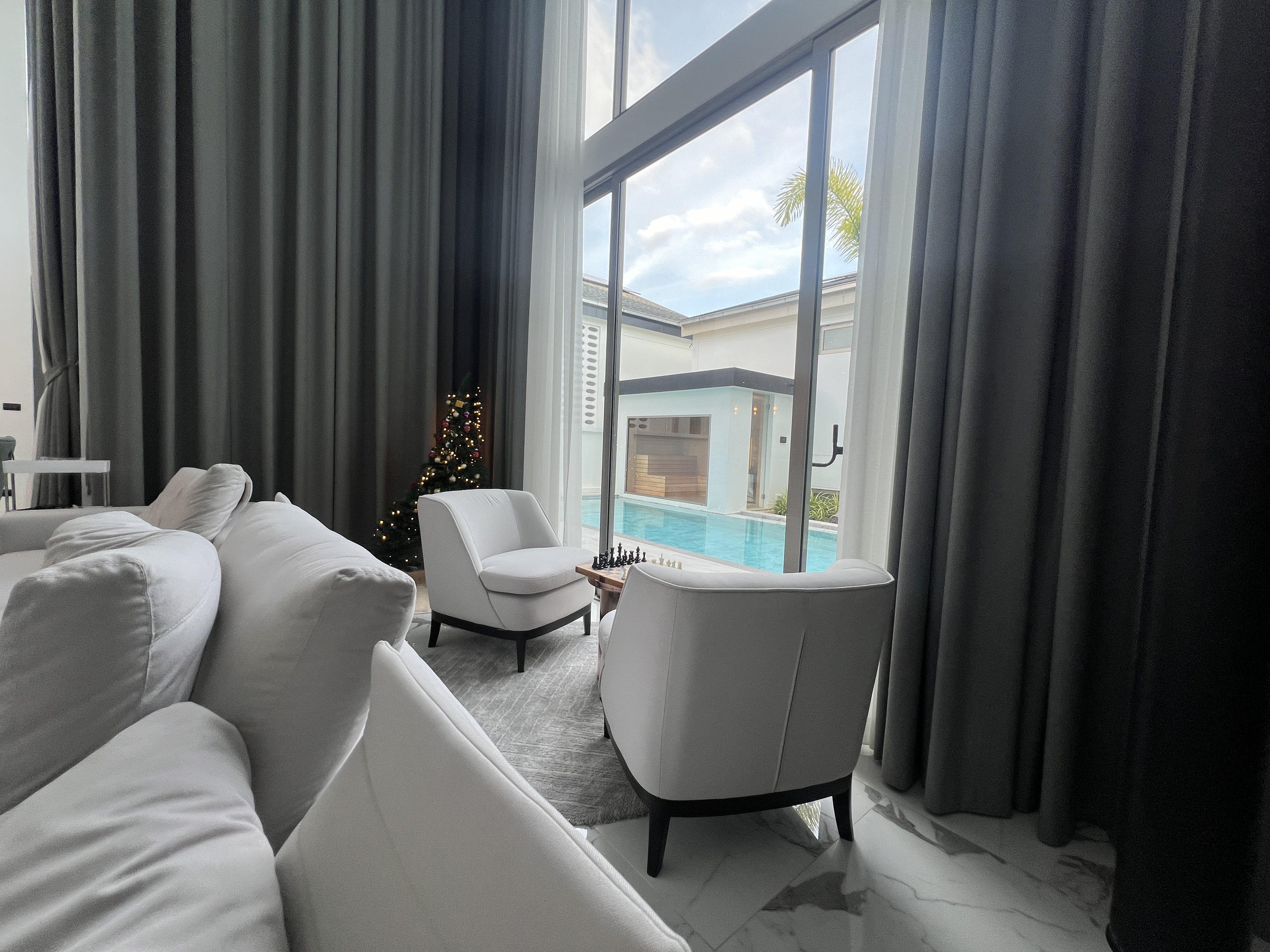 Living room seating area with pool view and festive decorations