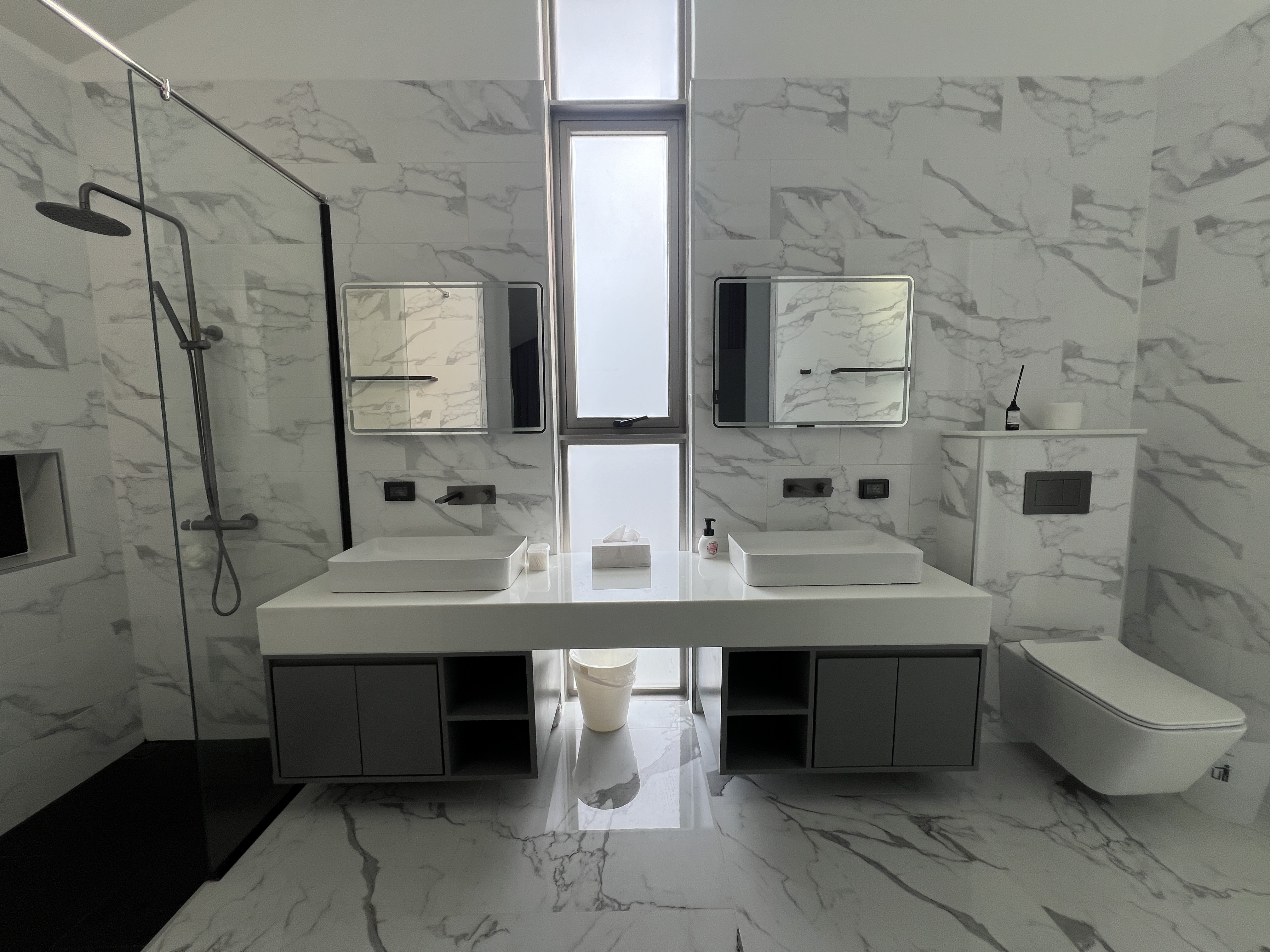 Luxury master bathroom with dual vanity and marble finishes